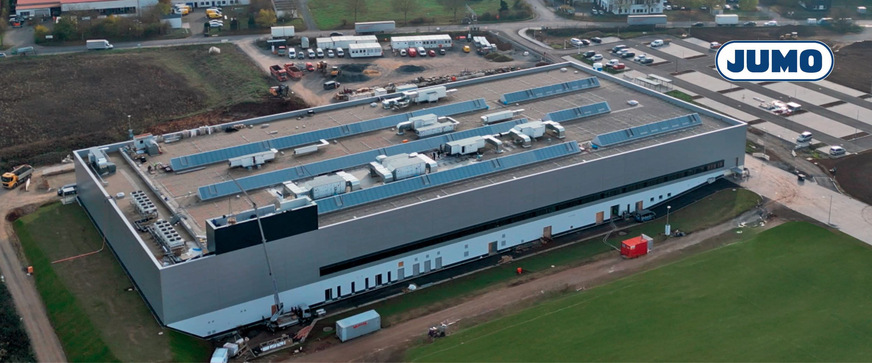 Bild 2 CO2-freies Jumo-Fertigungsgebäude in Fulda: Mit einer Investition von rund 50 Mio. Euro ist der Neubau mit 13.000 m2 Produktionsfläche für die Fertigung von Temperatur- und Drucksensoren im Technologiepark Fulda-West die größte Investition in der Jumo-Geschichte. Das innovative Energiekonzept von Sensilo wurde von der Europäischen Union kofinanziert und umfasst einen Sprinklertank als Energiespeicher sowie Wärmepumpen, 20 Erdwärmesonden à 100 m Tiefe, Kältemaschinen mit einer Leistung von 1200 kW und eine 700-kWp-Photovoltaik-Anlage. Dadurch lassen sich Lastspitzen kappen, Energiebedarfe zeitlich verschieben und Abwärme effizient nutzen, was den Einsatz fossiler Energieträger vor Ort überflüssig macht. Auch die CO2-Emissionen und der Primärenergieverbrauch werden deutlich reduziert.