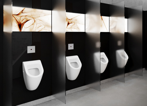 Viega: Die berührungslos auslösende Urinal-Betätigungsplatte „Visign for More 200 IR“ ist in den Ausführungen Holz Eiche gebeizt, Glas schwarz oder weiß und in diversen Kunststoff-Varianten erhältlich. - © Viega
