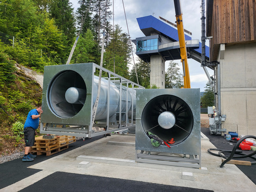 Endmontage des Windkanals im Adlerstadion in Hinterzarten: Die beiden Axialventilatoren von Helios Ventilatoren werden präzise auf die vorbereitenden Fundamente montiert... - © Helios Ventilatoren
