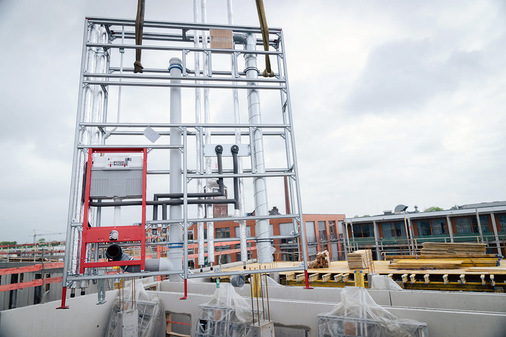  Mithilfe des Krans wurden die industriell vorgefertigten Installationswände von Tecesystem als Paket mit den entsprechenden Abladehilfen auf das Stockwerk gehoben.