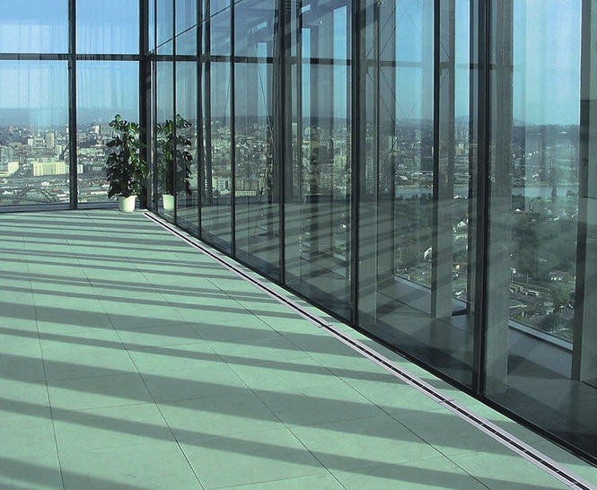 Schako: Fußbodenschlitzauslass FBS zur Abschirmung großer Glasfronten. - © Schako
