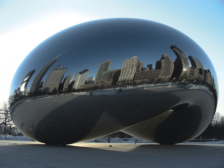 Hochhäuser aus zwei Jahrhunderten spiegeln sich im Cloud Gate (Wolkentor) des indisch-englischen Bildhauers Anish Kapoor, Chicagos meist fotografierter Sehenswürdigkeit. Die Skulptur aus hochglanzpoliertem Edelstahl in Form einer Bohne — von den Bürgern der Stadt deshalb “The Bean“ genannt — ist 10 m hoch, 20 m lang, 13 m breit und rund 100 t schwer.