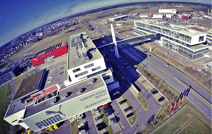 



1
 Das neue Verwaltungsgebäude PumaVision II (rechts) erfüllt die gleichen hohen Umweltstandards wie das PumaVision Headquarter (links): Eine Betonkerntemperierung sorgt in Verbindung mit Luft/Wasser-Wärmepumpen für eine energiesparende Beheizung und Kühlung. Eine Regenwassernutzungsanlage stellt den Großteil des Spülwassers für die WC-Anlagen bereit. 
